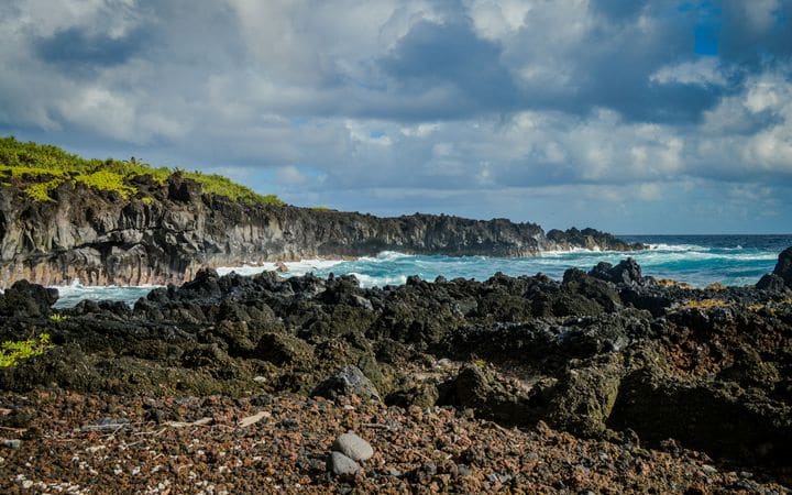 Black lava rock shoreline and blue surf at Waiʻānapanapa State Park on Maui