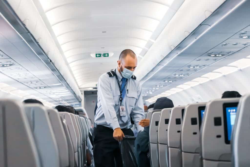 flight attendant cleaning plane