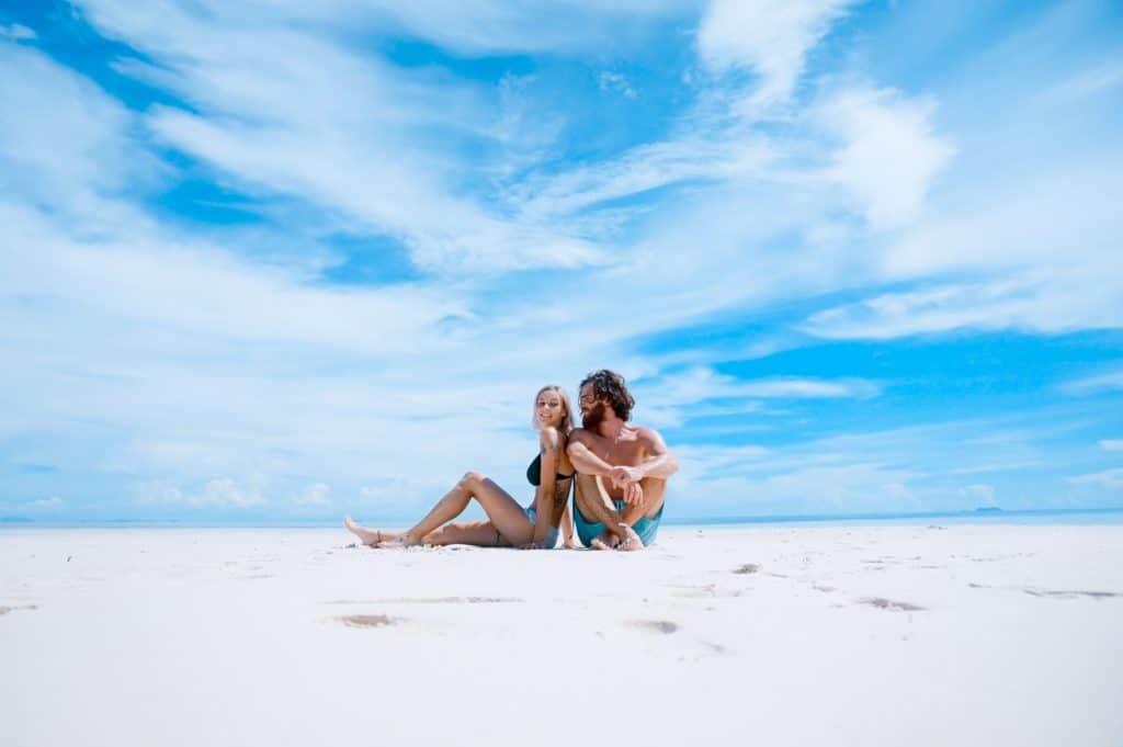 foreign nationals sitting on beach