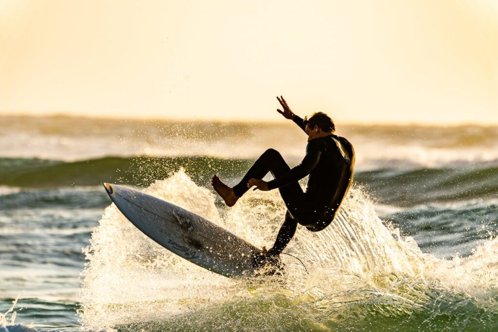 Beginner surfer riding a wave during a surf lesson in Hawaii